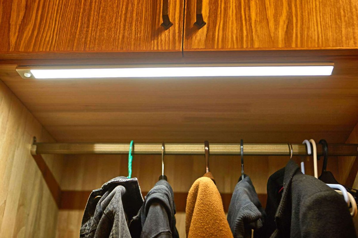 TUODI rechargeable sensor light bar lighting a wardrobe